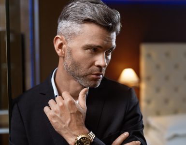 Club Model Estilos de Barba para Rosto Oval Redondo Quadrado Triangular Diamante Homem Queixo Handsome Man In Fashion Clothes In Luxury Interior. Closeup Portrait Of Successful Wealthy Confident Business Man In Stylish Elegant Suit, Expensive Watch In Fashionable Luxurious Apartment. Wealth